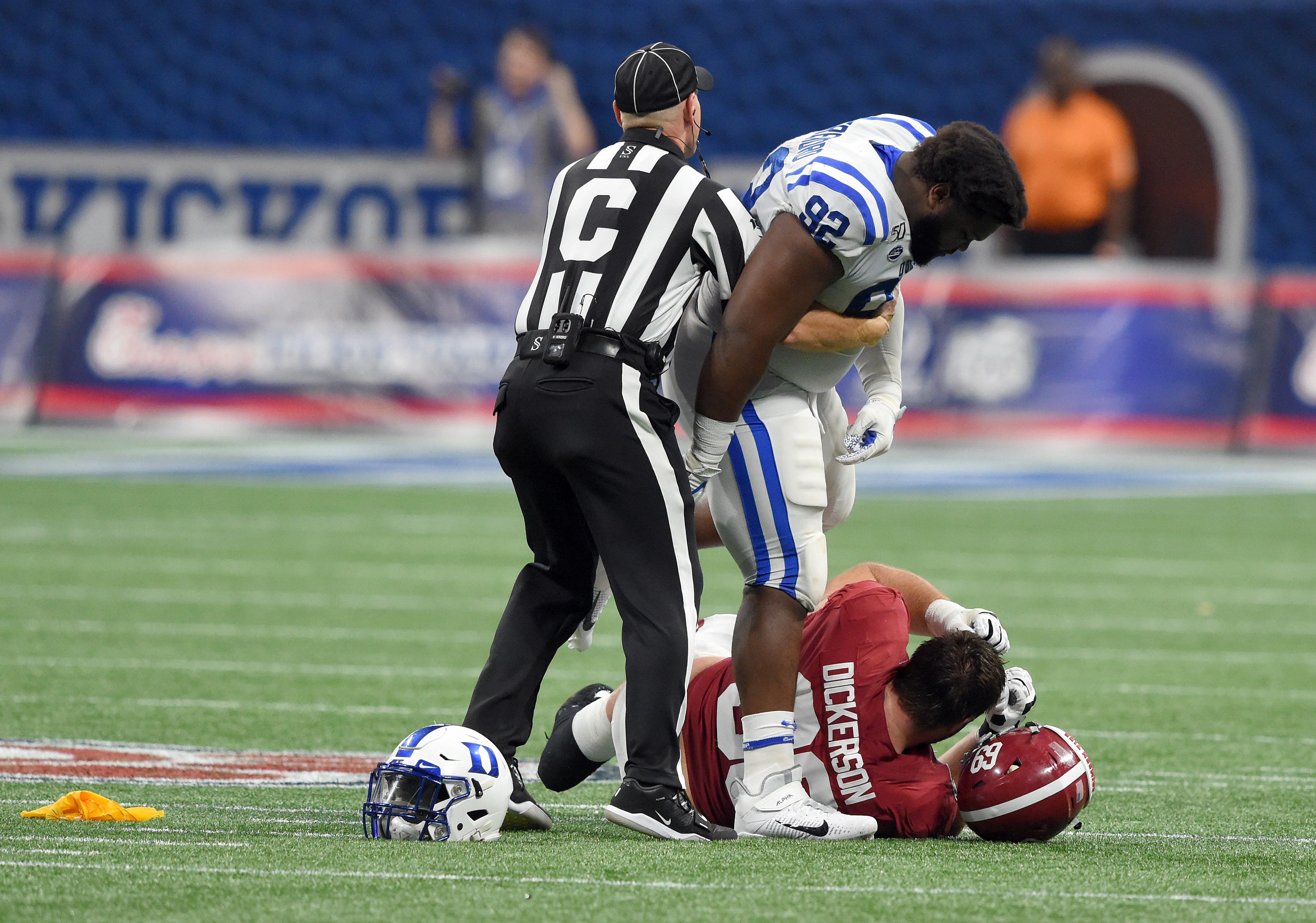 Aug 31, 2019; Atlanta, GA, USA; Duke Blue Devils defensive tackle Edgar Cerenord (92) gets restrained by an official as he hovers over Alabama Crimson Tide offensive lineman Landon Dickerson (69) during the third quarter at Mercedes-Benz Stadium. Cerenord was ejected from the game. Mandatory Credit: John David Mercer-USA TODAY Sports
