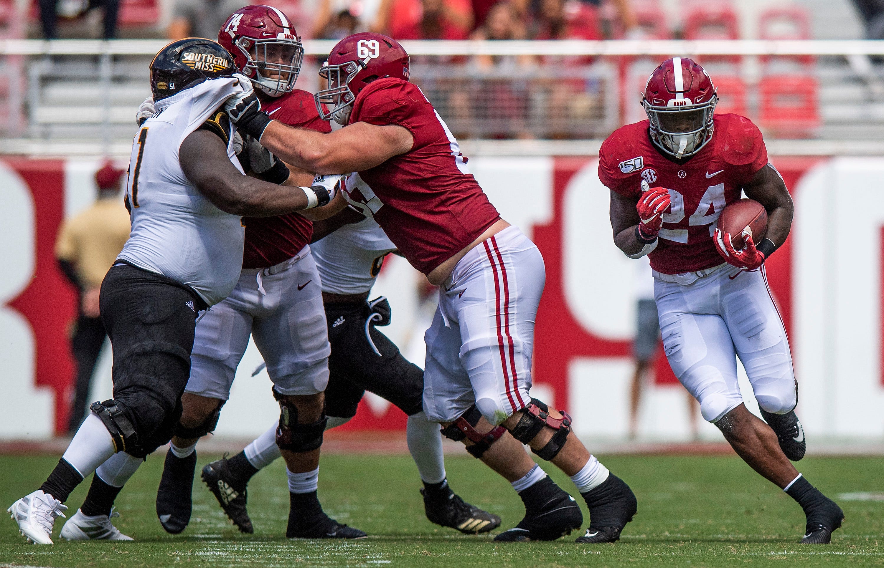 Alabama running back Brian Robinson, Jr., (24) carries behind the blocking of Alabama offensive linemen Landon Dickerson (69) and Jedrick Wills, Jr., (74) against Southern Miss at Bryant-Denny Stadium in Tuscaloosa, Ala., on Saturday September 21, 2019.