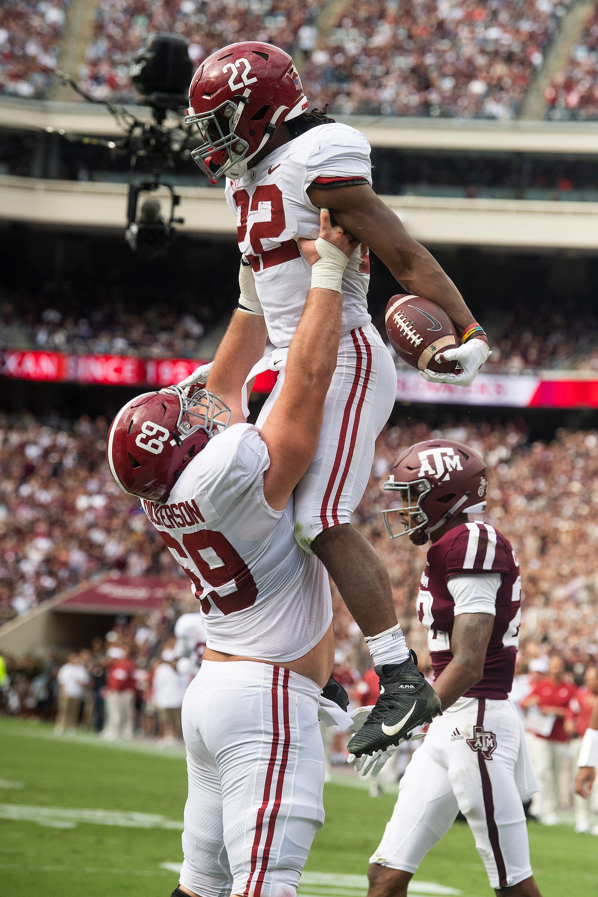 Alabama running back Najee Harris (22) is lifter by Alabama offensive lineman Landon Dickerson (69) after scoring a touchdown against Texas A&M at Kyle Field in College Station, Texas on Saturday October 12, 2019.