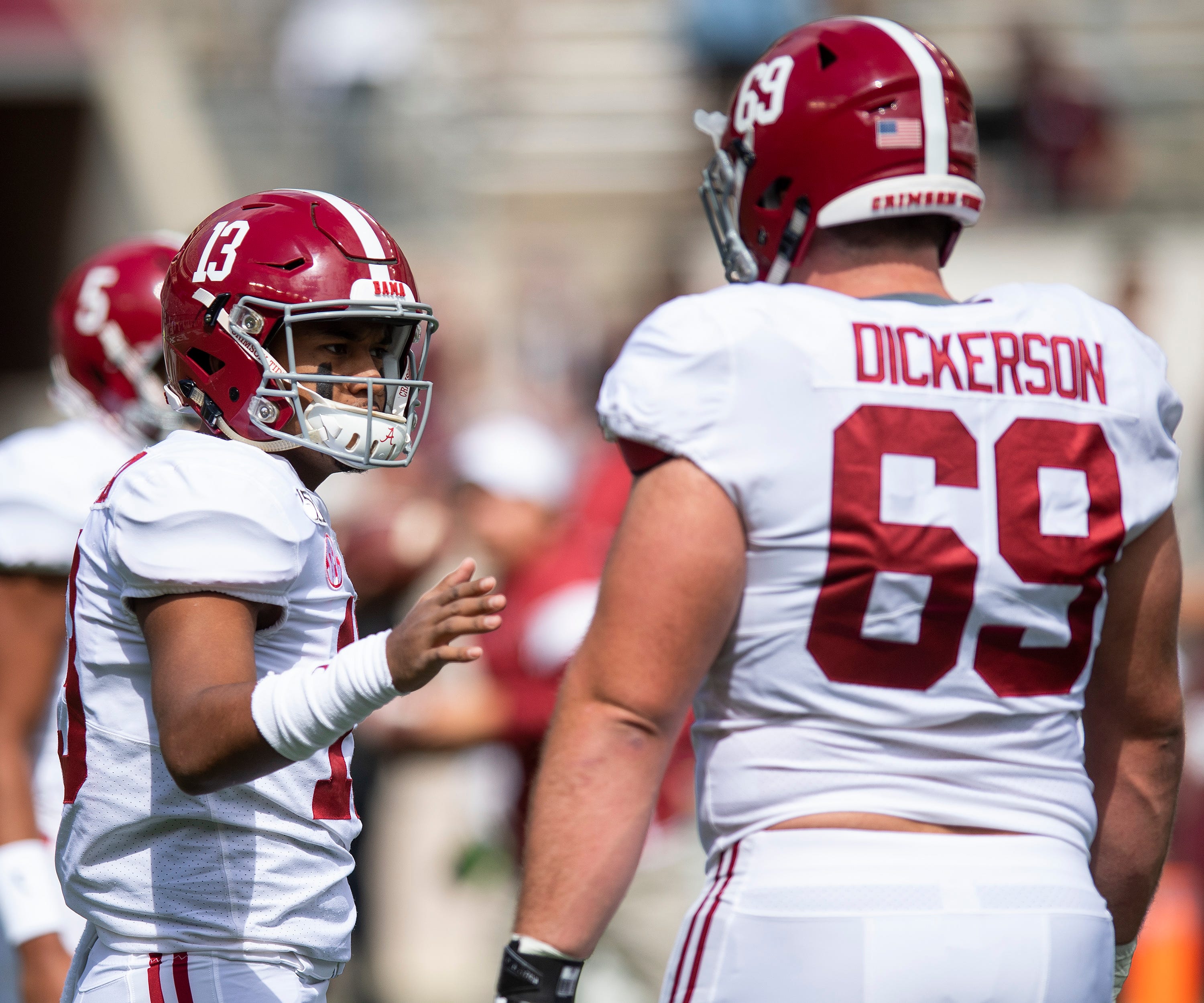 Alabama quarterback Tua Tagovailoa (13) talks with offensive lineman Landon Dickerson (69) before the Texas A&M game at Kyle Field in College Station, Texas on Saturday October 12, 2019.