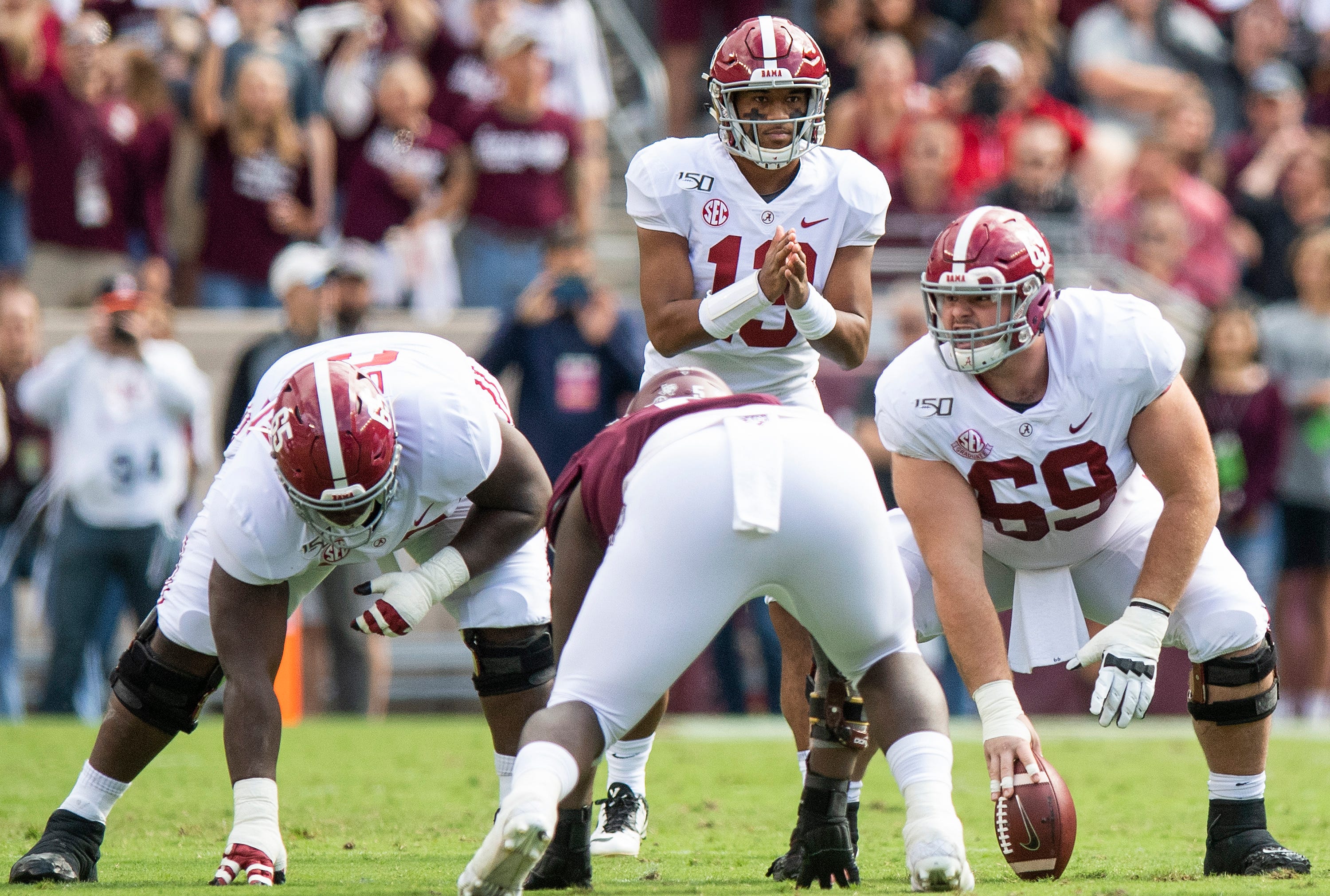 Alabama offensive linemen Deonte Brown (65) and Landon Dickerson (69) line up in front of quarterback Tua Tagovailoa (13) against Texas A&M at Kyle Field in College Station, Texas on Saturday October 12, 2019.