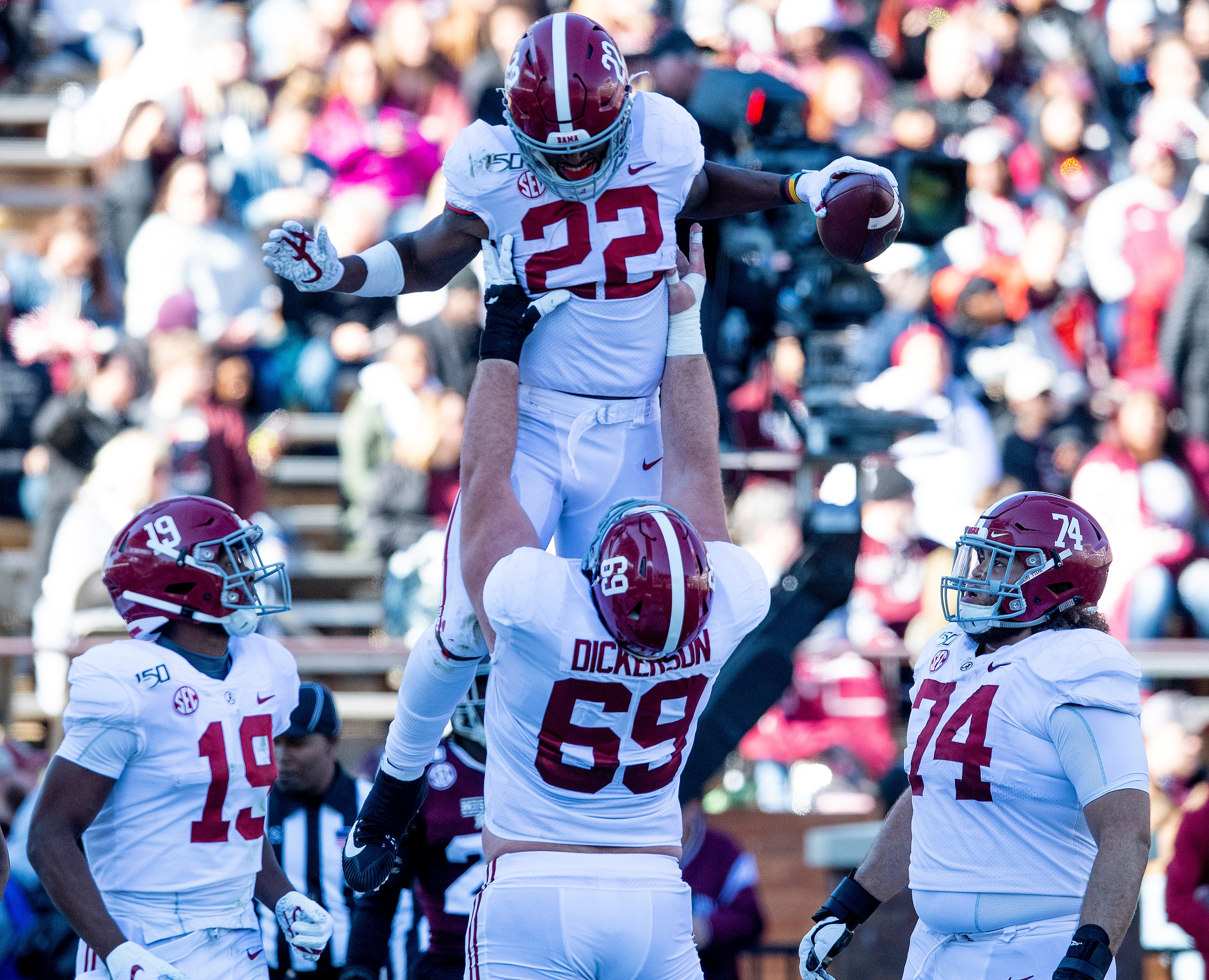 Alabama running back Najee Harris (22) is lifted by offensive lineman Landon Dickerson (69) after scoring against Mississippi State at Davis Wade Stadium on the MSU campus in Starkville, Ms., on Saturday November 16, 2019.