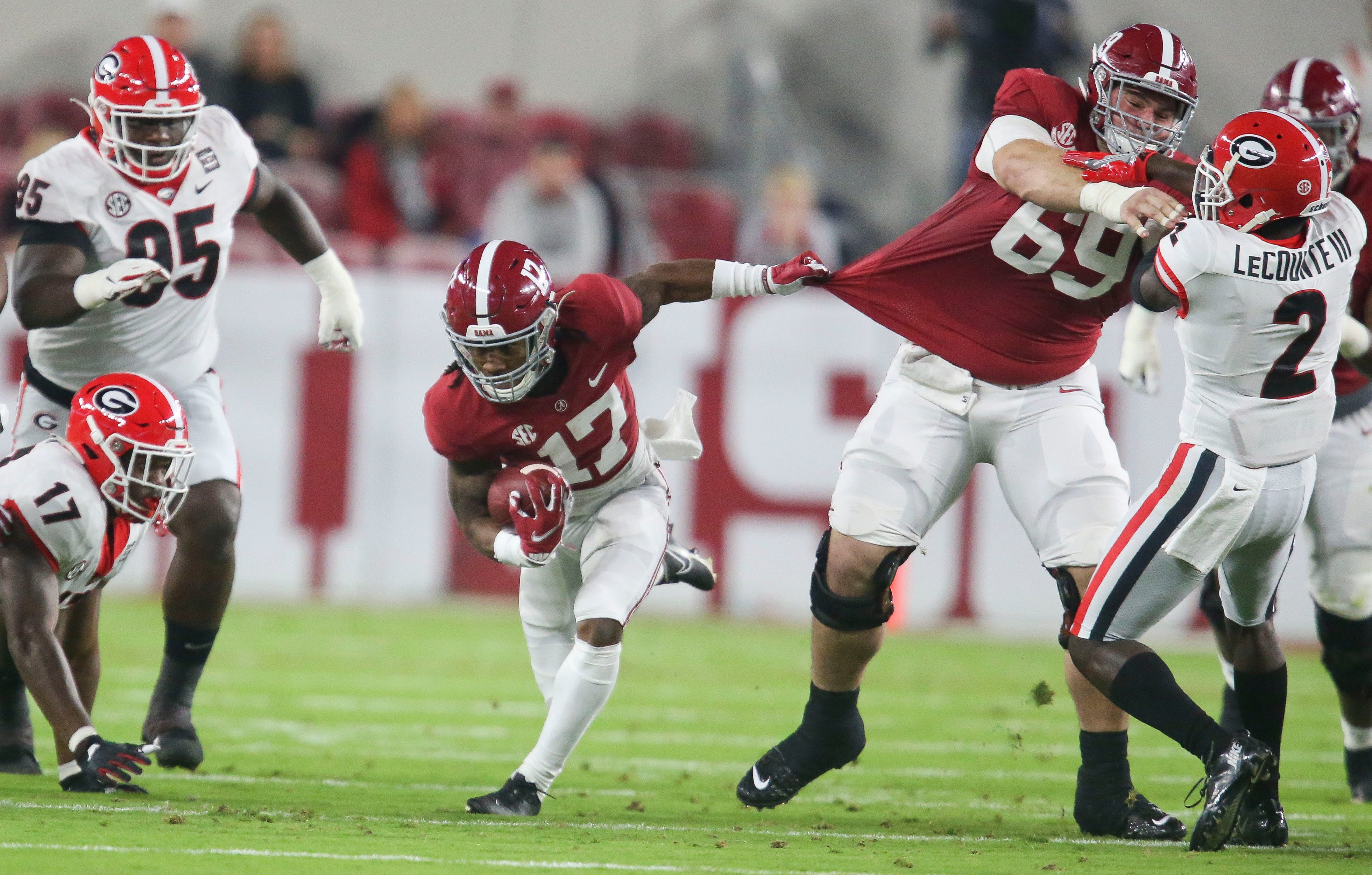 Alabama wide receiver Jaylen Waddle (17) grabs Alabama offensive lineman Landon Dickerson (69) by the jersey sa he slingshots through a hole during Alabama's 41-24 win over Georgia in Bryant-Denny Stadium Saturday, Oct. 17, 2020. [Staff Photo/Gary Cosby Jr.]