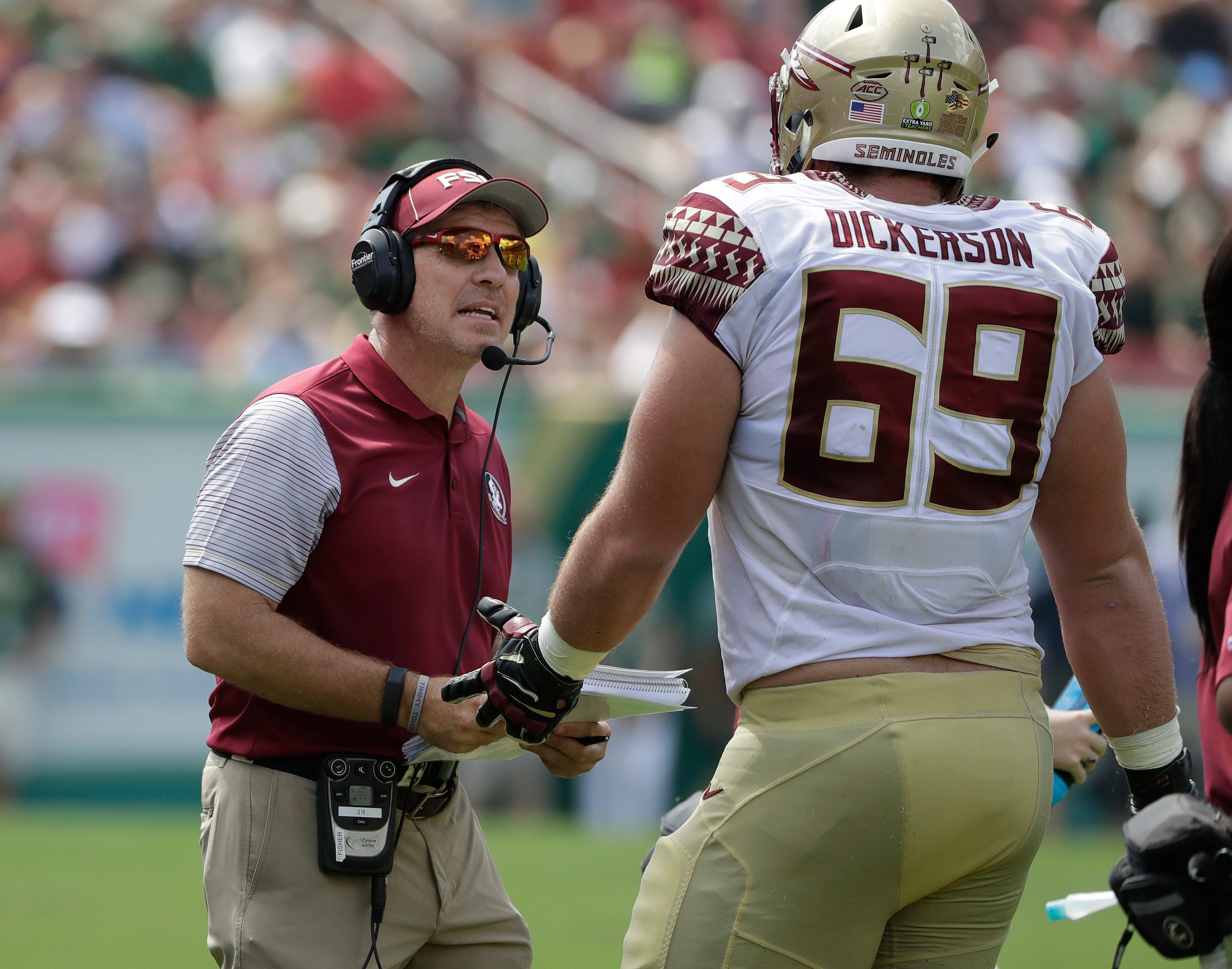 Florida State head coach Jimbo Fisher, left, talks to offensive lineman Landon Dickerson (69) during the first quarter of an NCAA college football game against South Florida Saturday, Sept. 24, 2016, in Tampa, Fla. (AP Photo/Chris O'Meara)