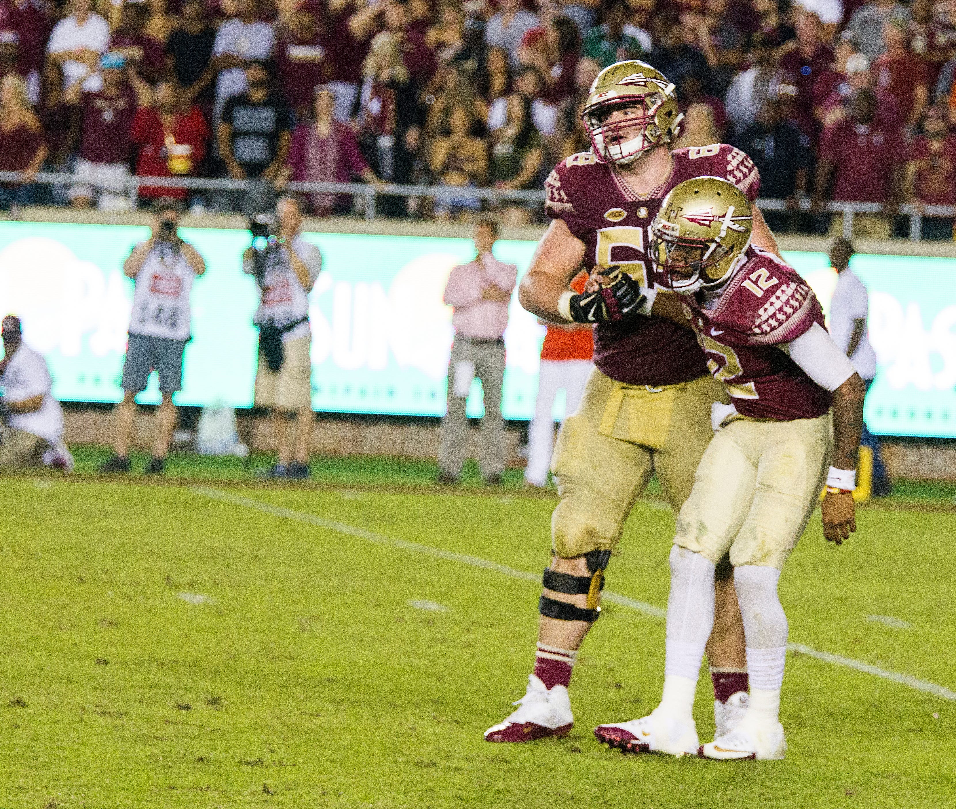Florida State offensive lineman Landon Dickerson helps quarterback Deondre Francois up aft4er being hit by the Clemson defense in the second half of an NCAA college football game in Tallahassee, Fla., Saturday, Oct. 29, 2016. Clemson defeated Florida State 37-34. (AP Photo/Mark Wallheiser)
